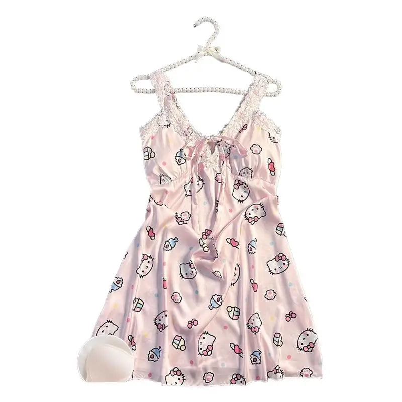 Pink baby dress with Hello Kitty print on a hanger against a white background