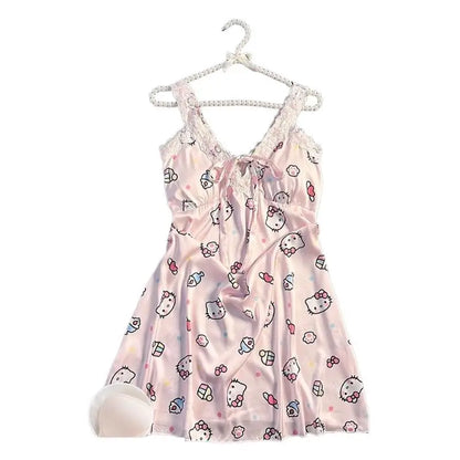 Pink baby dress with Hello Kitty print on a hanger against a white background