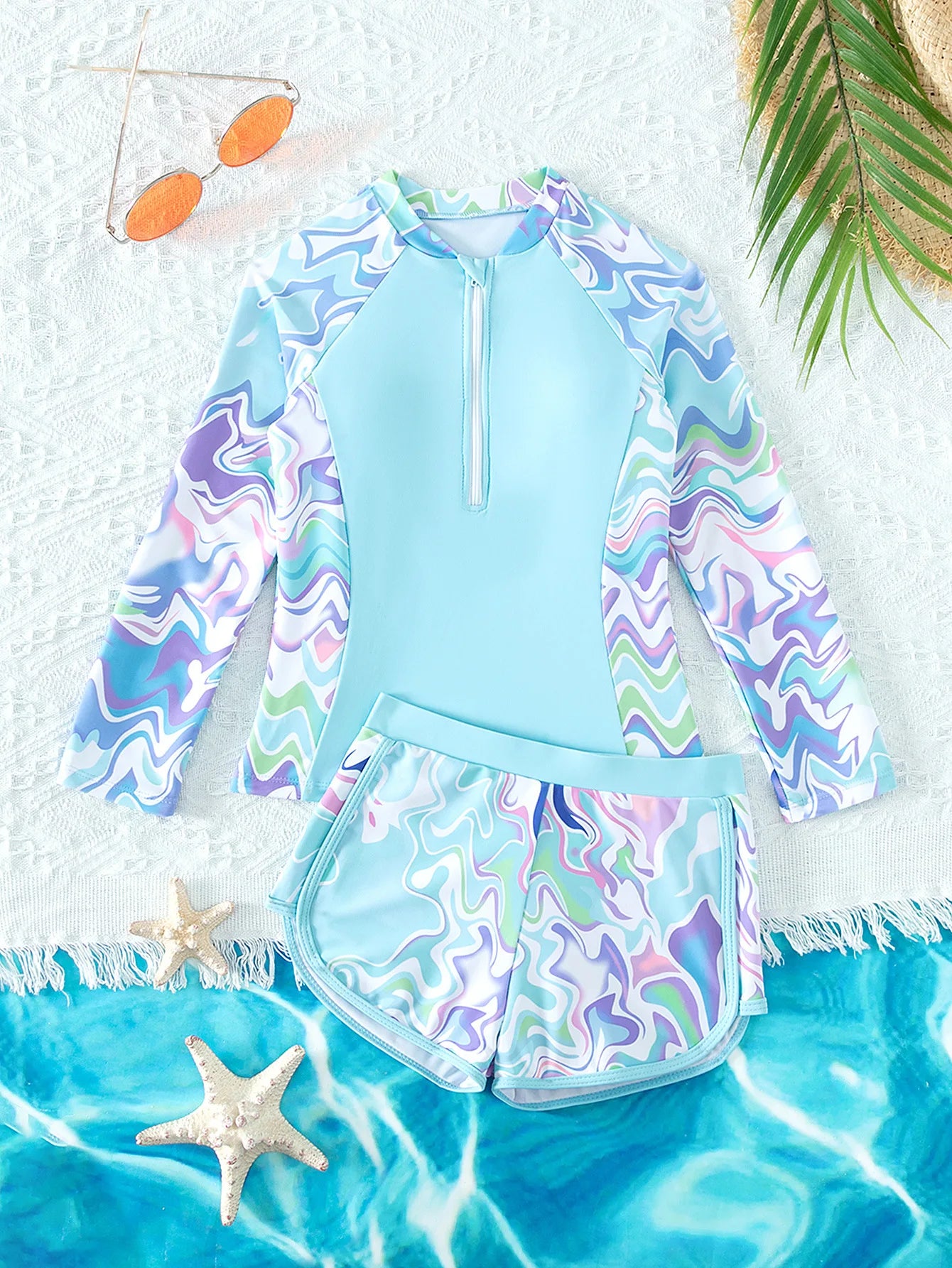 Children's swimsuit set with colorful pattern on a beach-themed background