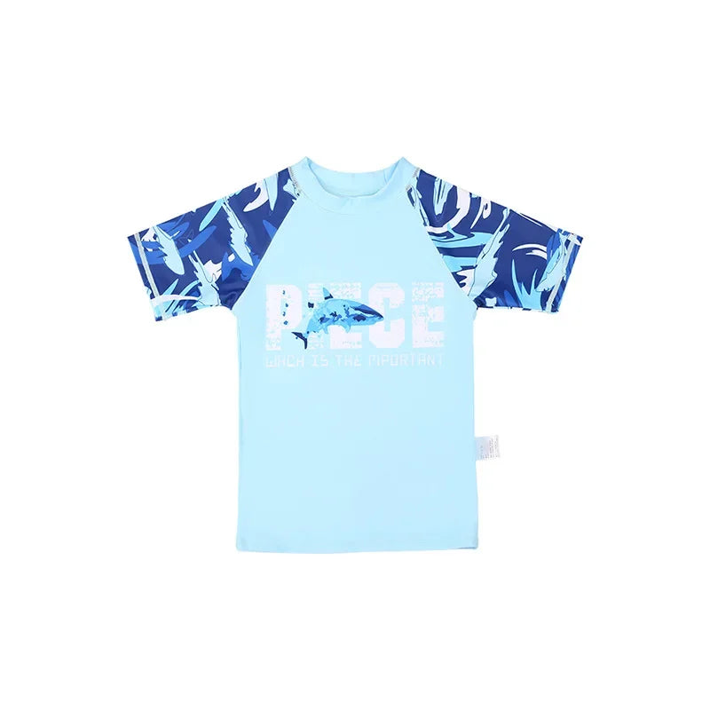 Children's light blue and navy shirt with shark design on a white background