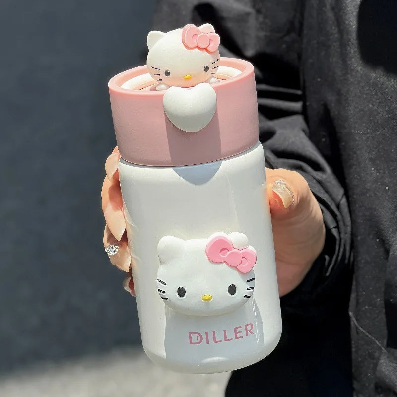 Hello Kitty-themed water bottle held by a person with a dark background