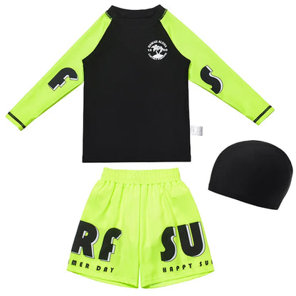 Children's swim set with black and green rash guard, shorts, and cap on a white background