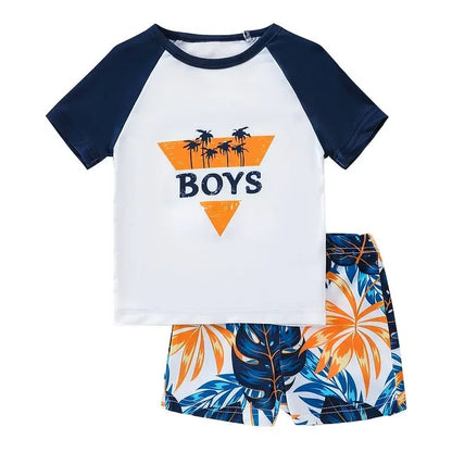 Children's outfit with white and navy shirt and leaf-patterned shorts on a white background