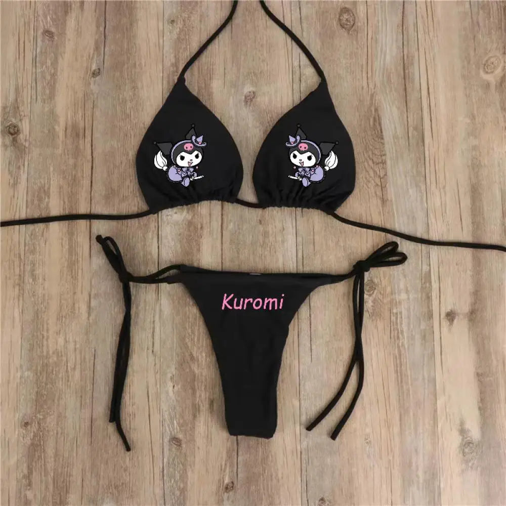 Black bikini set with cartoon character design on a wooden surface