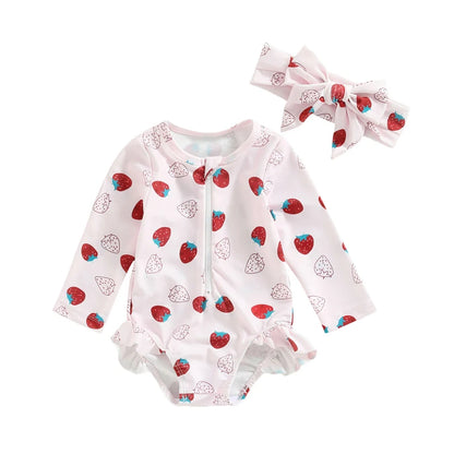 Baby romper with strawberry pattern and matching headband on a white background