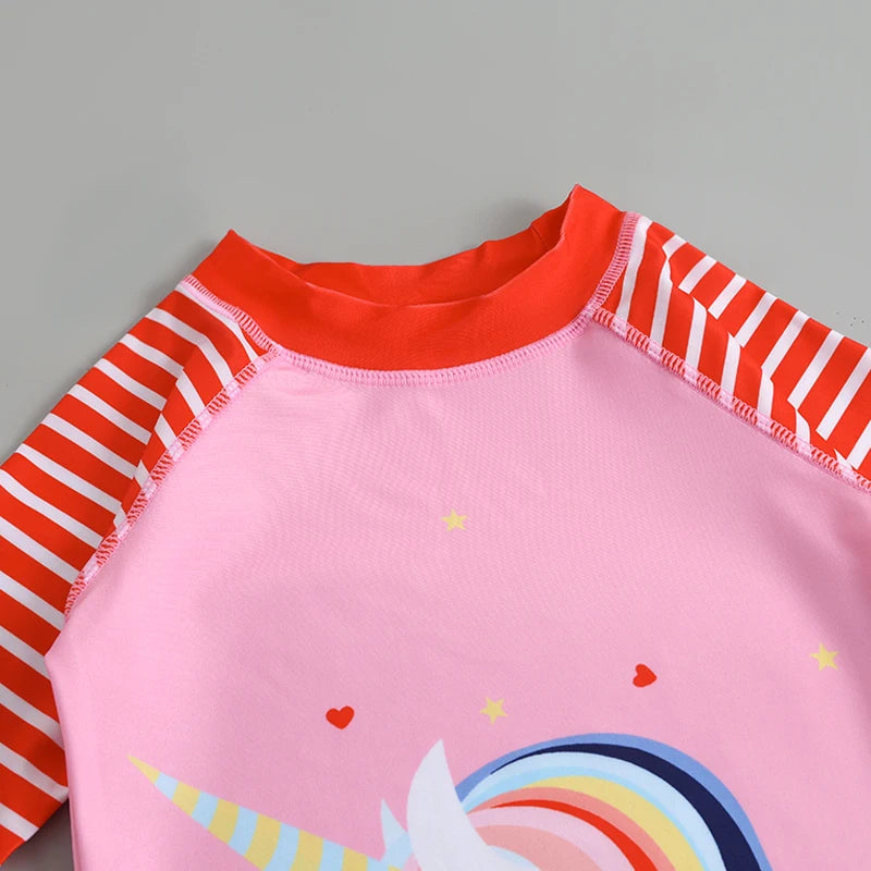 Pink children's swimsuit with red and white striped sleeves on a gray background