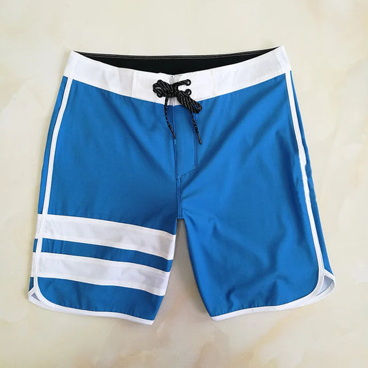 Blue swim shorts with white stripes on a beige background