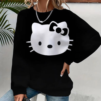 Black sweatshirt with a white cat face design worn by a person against a light background