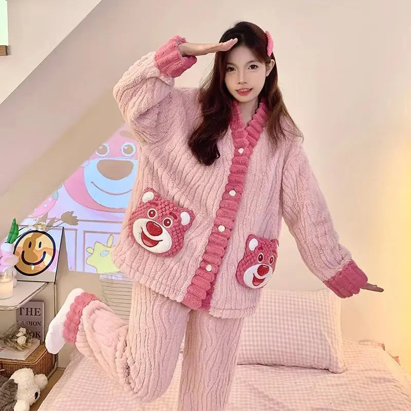 Person wearing a pink knitted outfit with bear face designs in a cozy room.