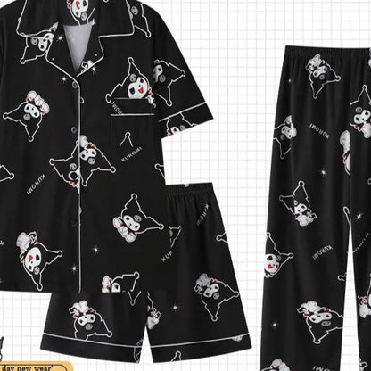 Black pajama set with cartoon dog design on a checkered background, labeled 'PAJAMS'.