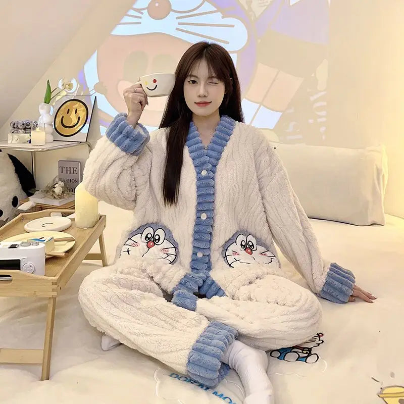 Person wearing a cozy pajama set with cartoon characters, sitting on a bed holding a mug.