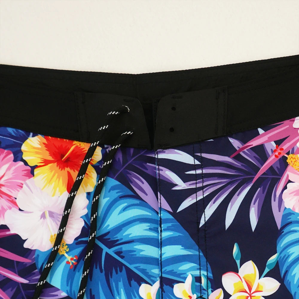Close-up of a colorful tropical floral pattern on a black background