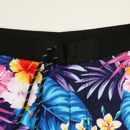 Close-up of a colorful tropical floral pattern on a black background