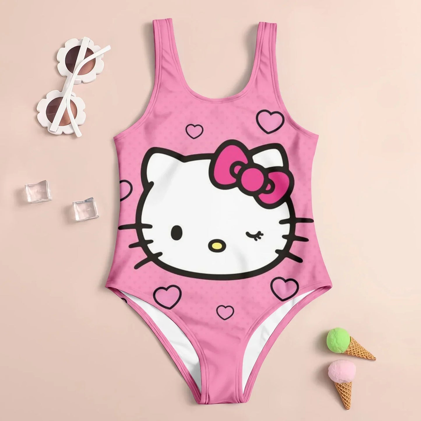 Pink swimsuit with Hello Kitty design on a beige background
