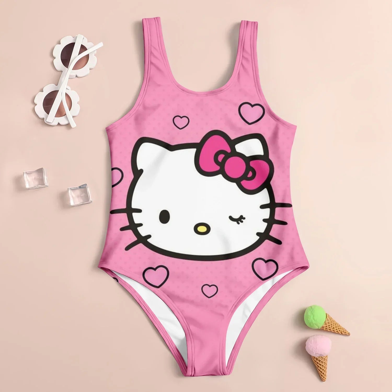Pink swimsuit with Hello Kitty design on a beige background