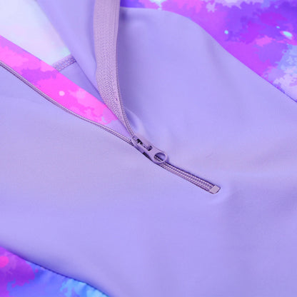 Close-up of a purple garment with a zipper, featuring a tie-dye pattern in the background.