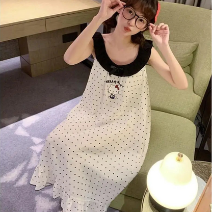 Woman in a polka dot dress sitting on a couch in a living room.