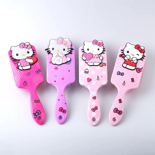 Four pink Hello Kitty hairbrushes on a white background