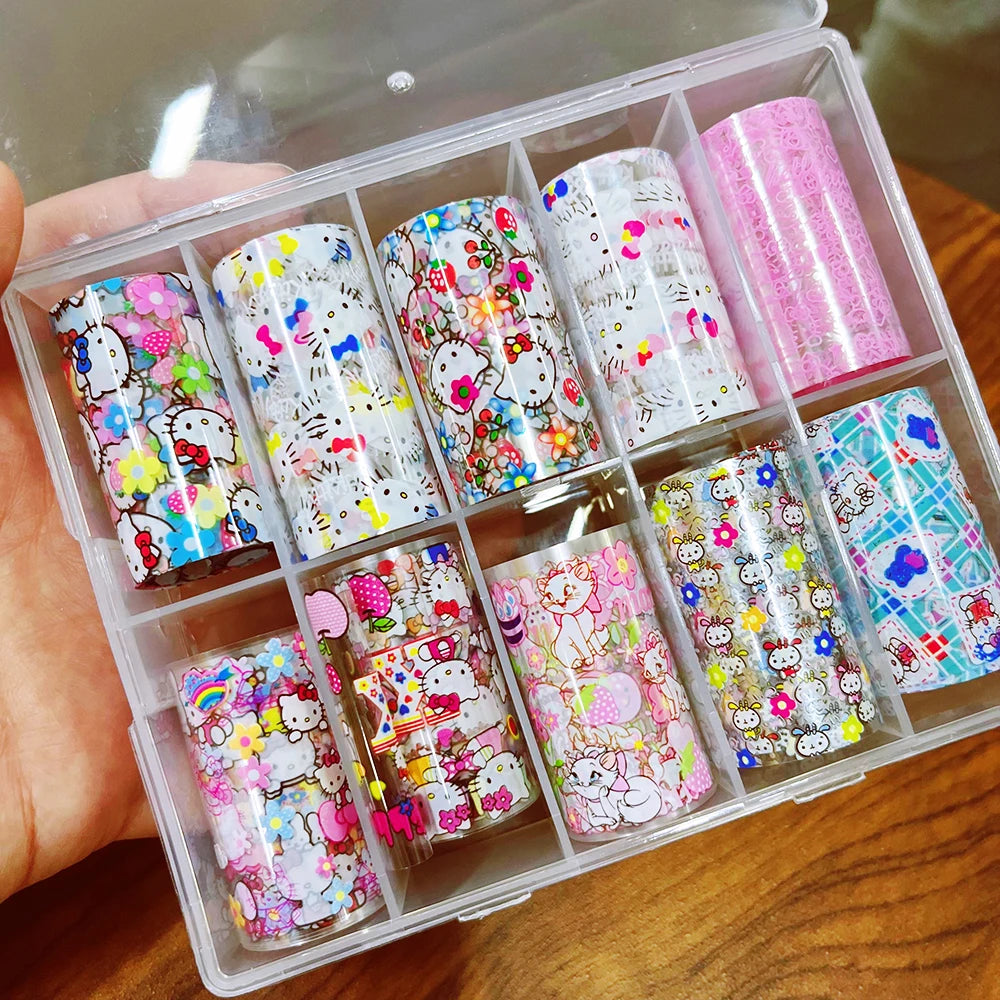 Set of colorful nail art stickers in a clear plastic case on a wooden surface.
