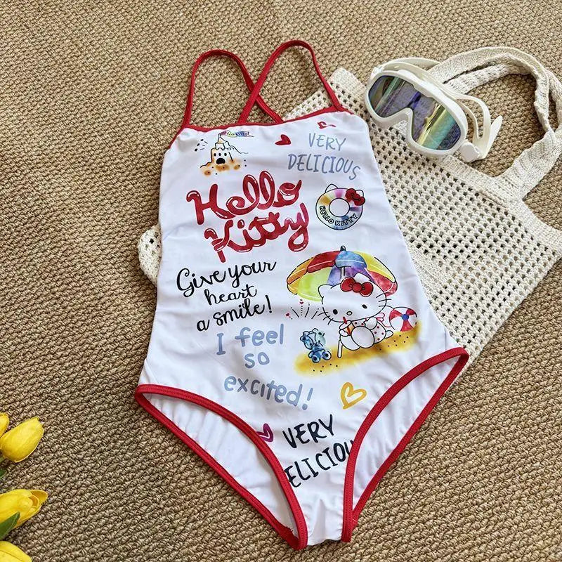 Hello Kitty swimsuit with red straps on a textured surface