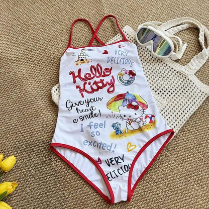 Hello Kitty swimsuit with red straps on a textured surface
