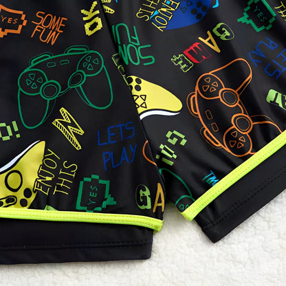 Black shorts with colorful gaming-themed designs on a white surface