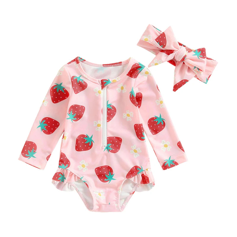 Baby onesie with strawberry pattern and matching headband on a white background
