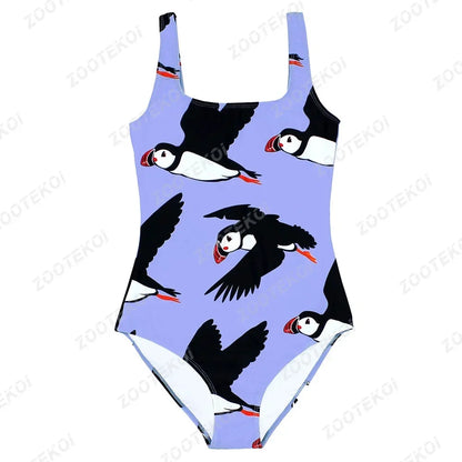 One-piece swimsuit with puffin pattern on a light purple background