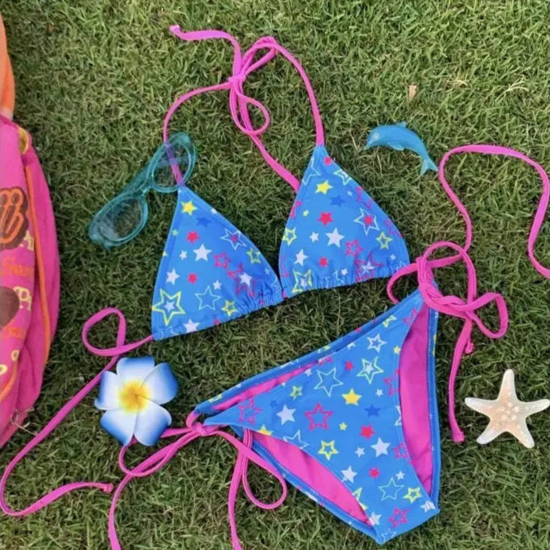 Blue bikini with pink straps on grass
