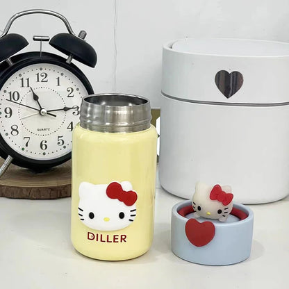 Yellow water bottle with Hello Kitty design and a small figurine on a white surface.