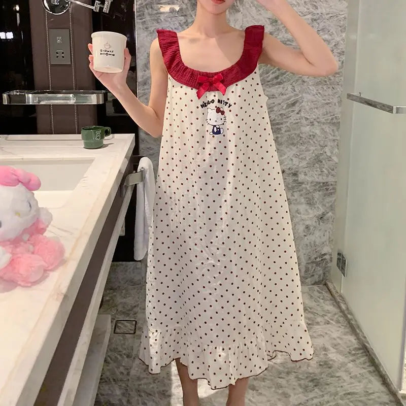 Person wearing a polka dot dress with a red collar in a bathroom.