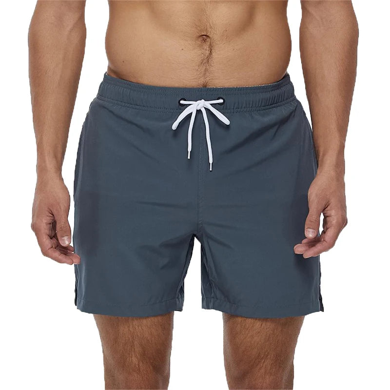 Gray swim shorts with a white drawstring on a white background