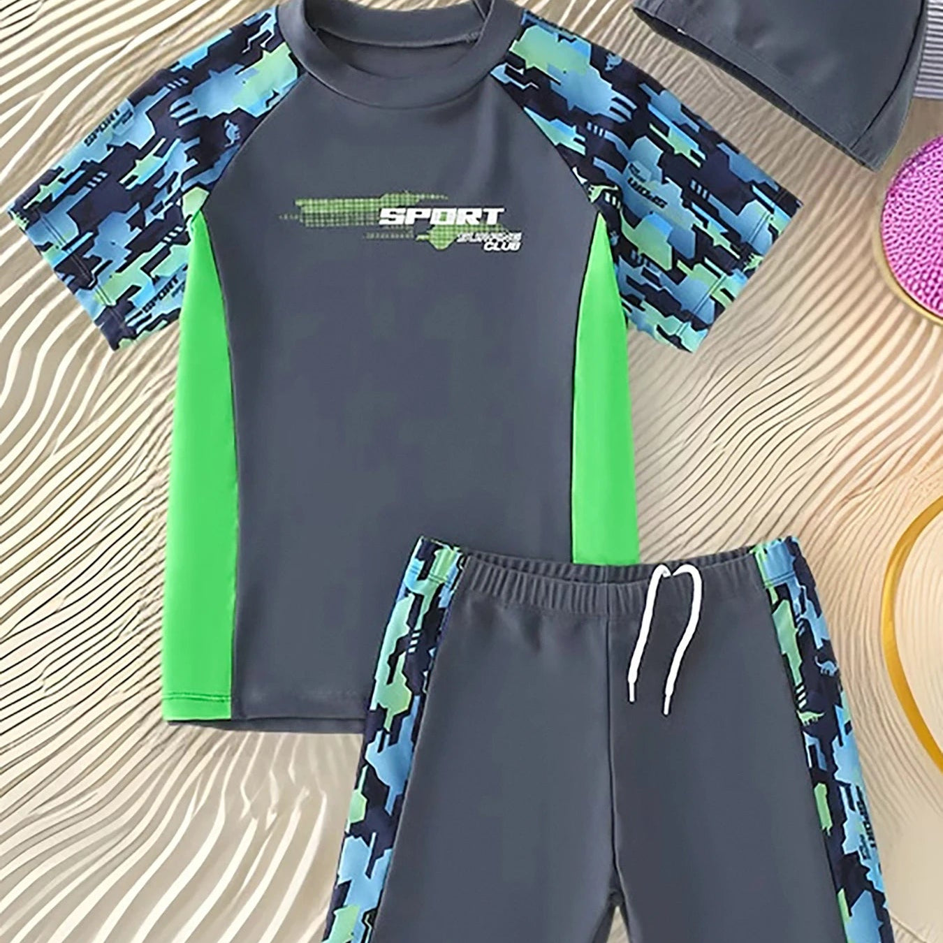 Children's swim set with blue and green camouflage pattern on a textured surface