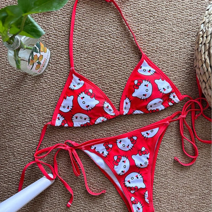 Red bikini set with white cat print on a textured surface