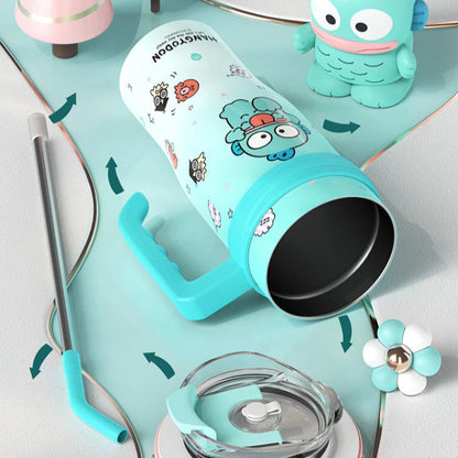 Turquoise tumbler with cartoon character design on a white surface with decorative items.
