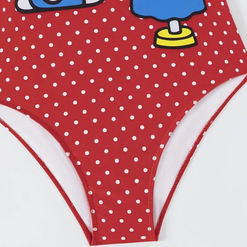 Red polka dot swimsuit bottom with cartoon character on a white background