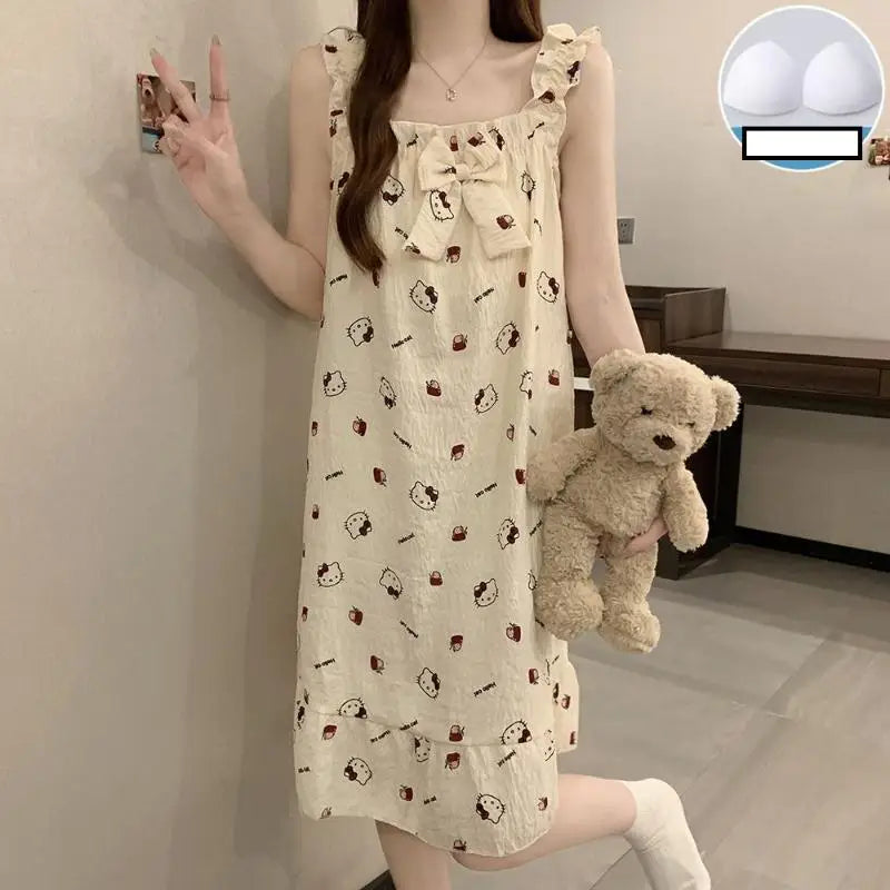 Woman in a patterned dress holding a teddy bear in a room.