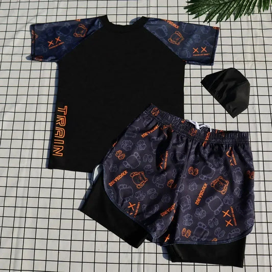 Black and navy children's outfit with patterned design on a grid background