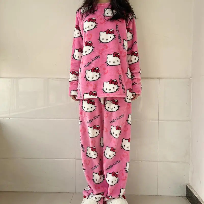 Pink 'Hello Kitty' pajama set worn by a person against a tiled wall.