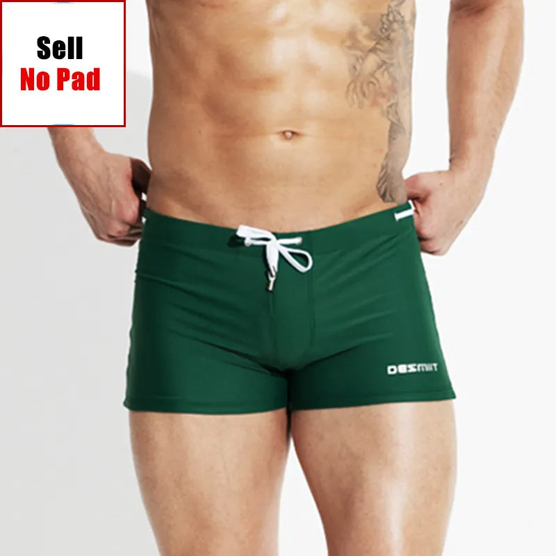 Green swim shorts with a brand logo on a plain background