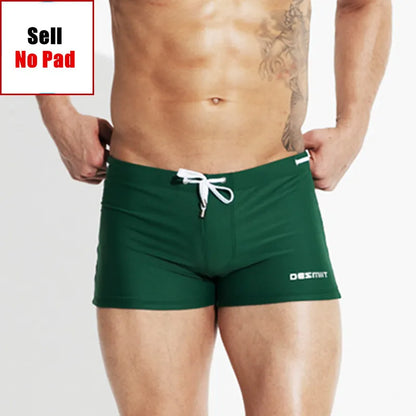 Green swim shorts with a brand logo on a plain background