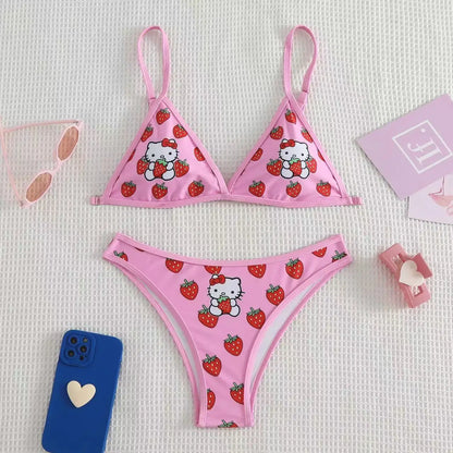 Pink bikini set with Hello Kitty and strawberry pattern on a light gray background