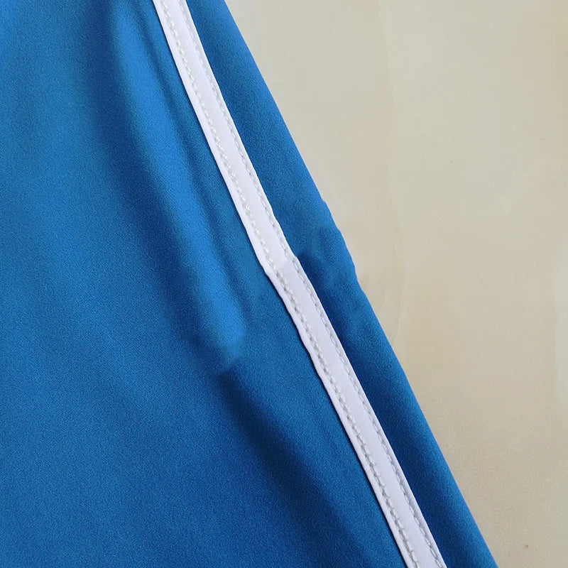 Blue fabric with a white stripe on a beige background
