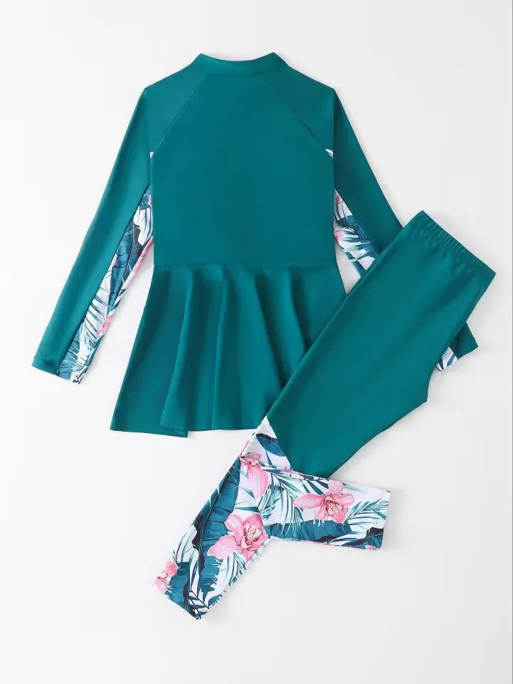 Teal swimsuit set with floral sleeves and matching headband on a white background