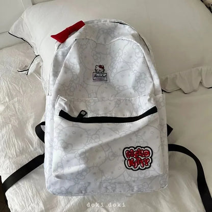 White backpack with black straps on a white surface