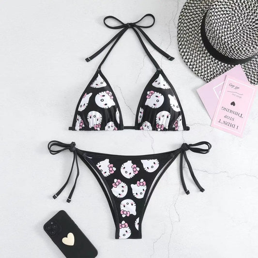 Black bikini with white cat pattern on a light gray background