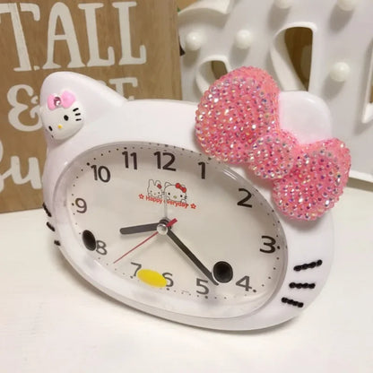 Hello Kitty clock with a pink bow on a white surface