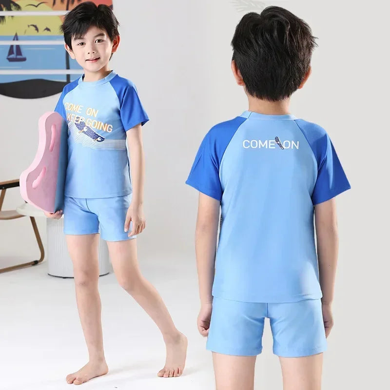 Child wearing a blue and gray swim set with 'COME ON' text, holding a pink float.