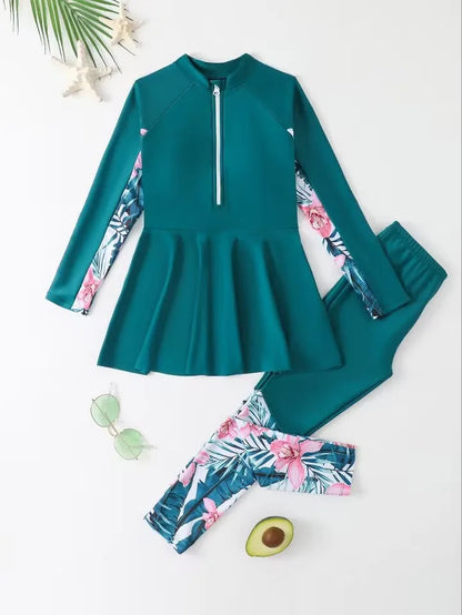 Teal swimsuit with floral sleeves and pants on a white background