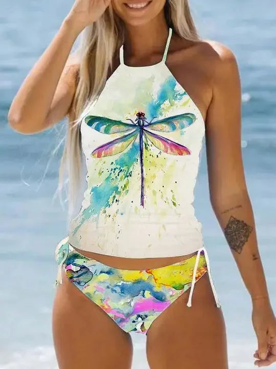Woman wearing a colorful dragonfly-themed bikini set with a blurred beach background